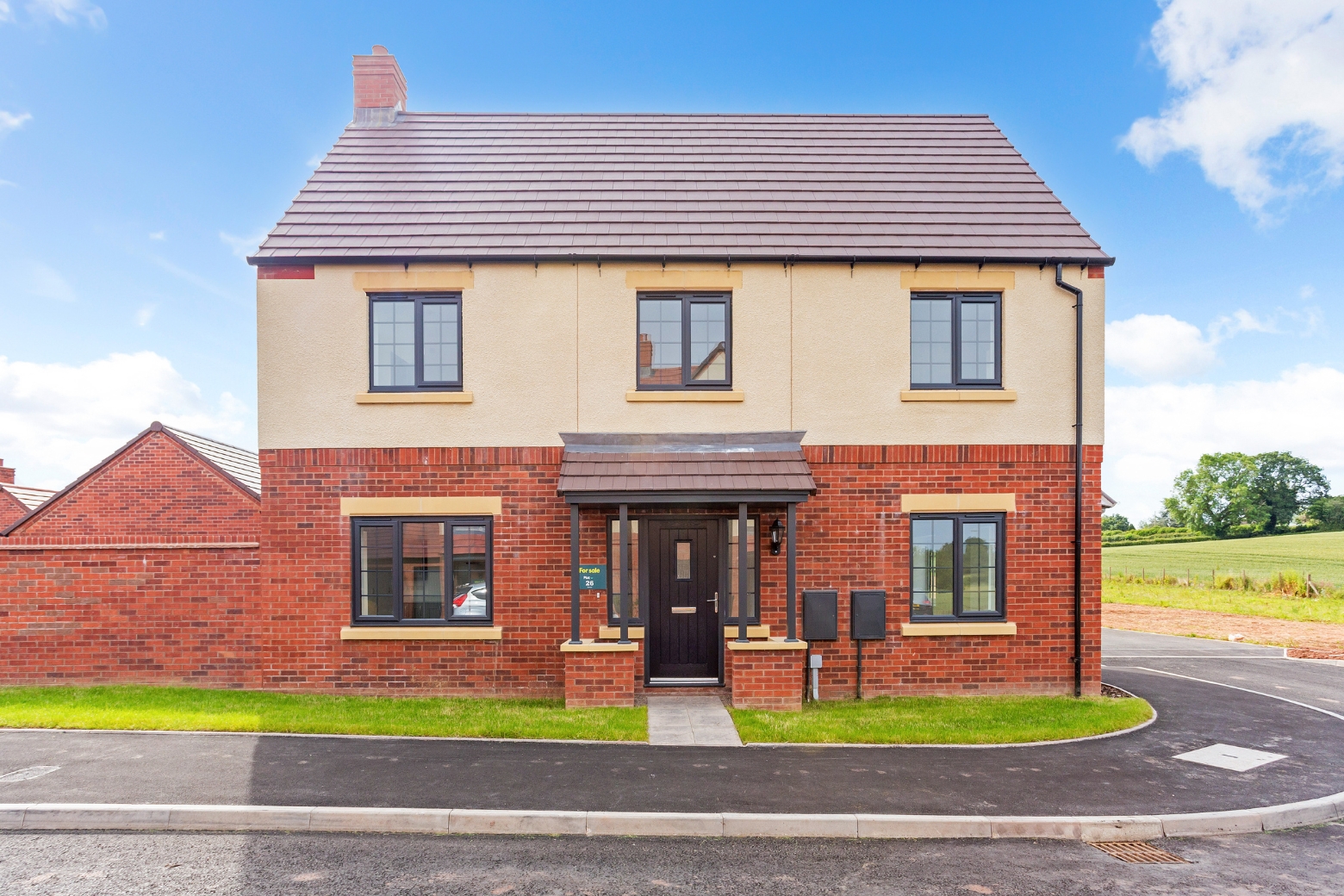 A double-fronted detached house on the corner of a housing estate