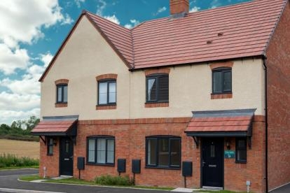 Modern semi-detached home with red brick and cream exterior, tiled roof, and two porches. Located with countryside views.