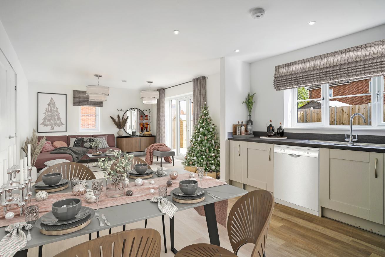 An open plan kitchen dining and living area with Christmas decorations and a christmas tree