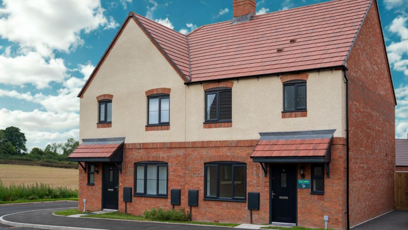 Modern semi-detached home with red brick and cream exterior, tiled roof, and two porches. Located with countryside views.