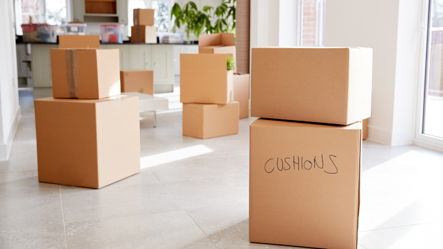 A pile of moving boxes spread across the floor